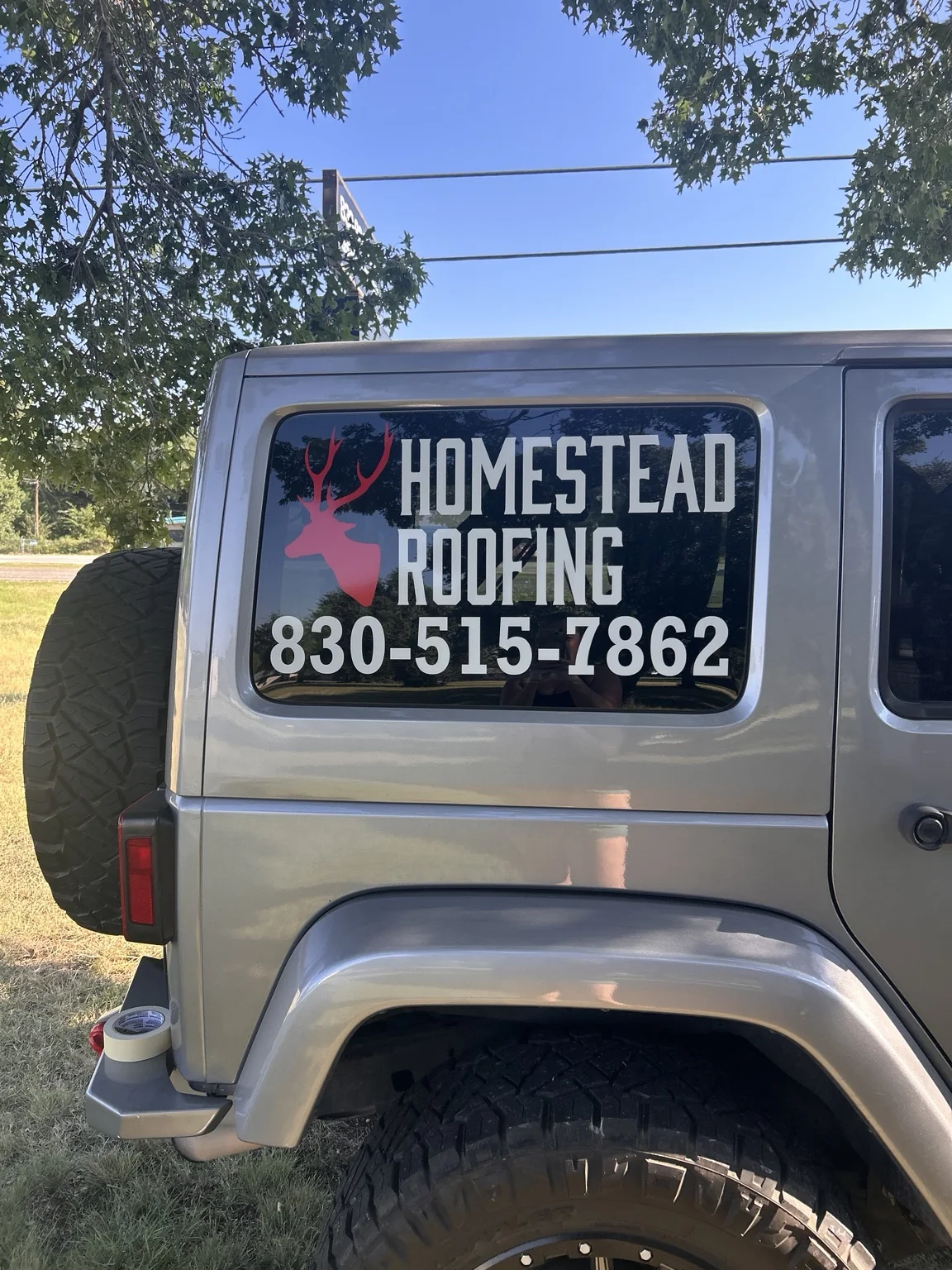 Homestead Roofing vehicle window graphic